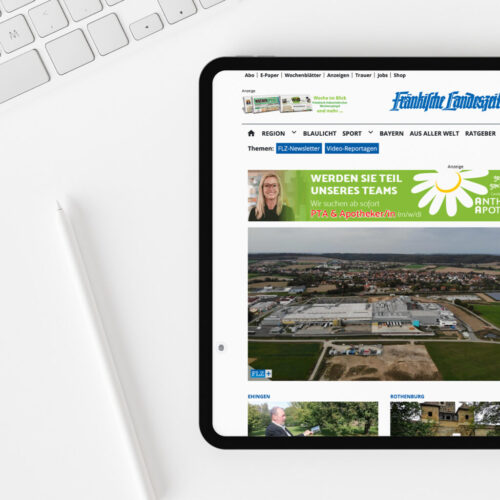 Top view of blank screen tablet on white working desk
